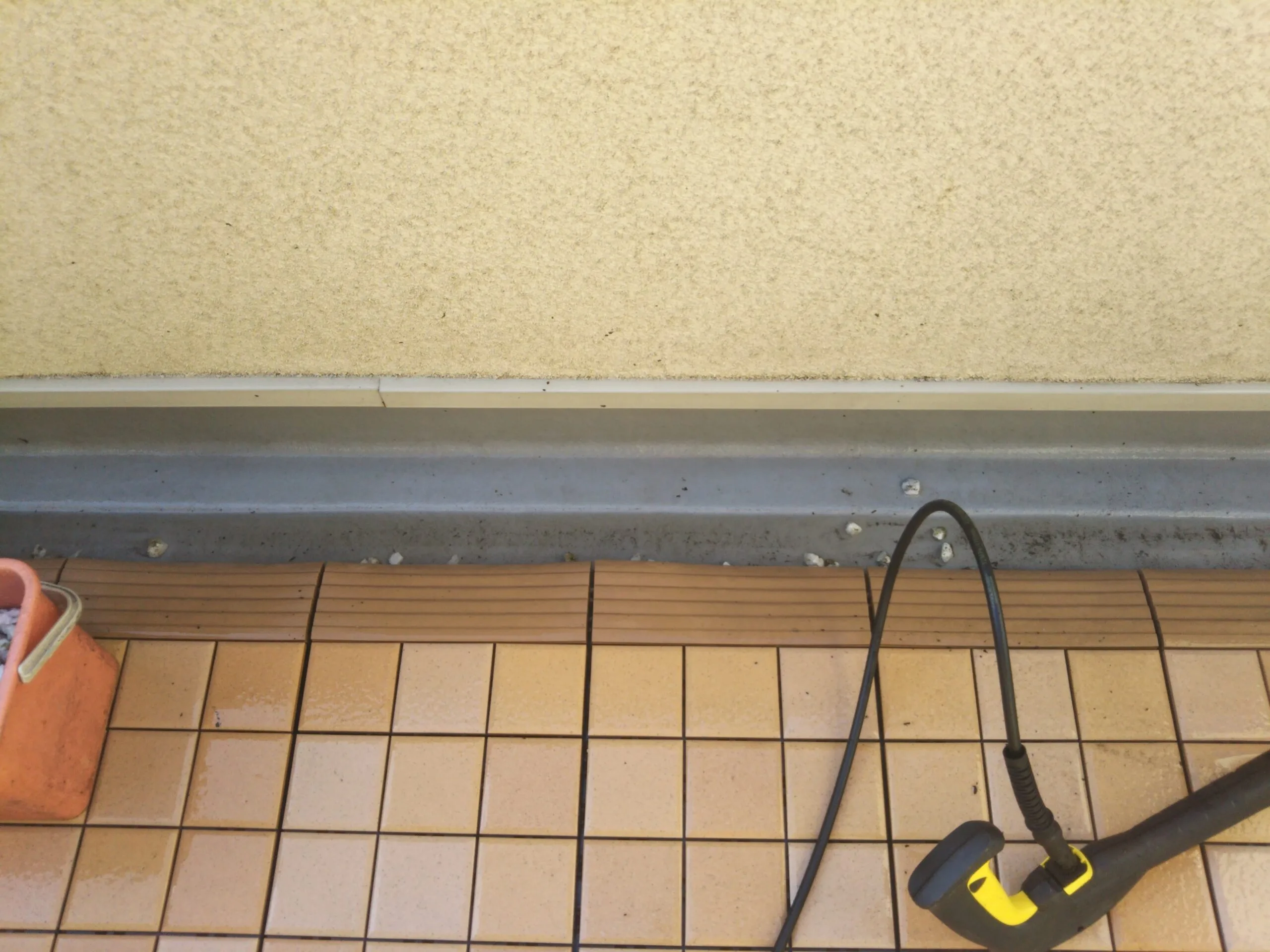 窓のサッシレールを専用機器で清掃している作業中の様子
